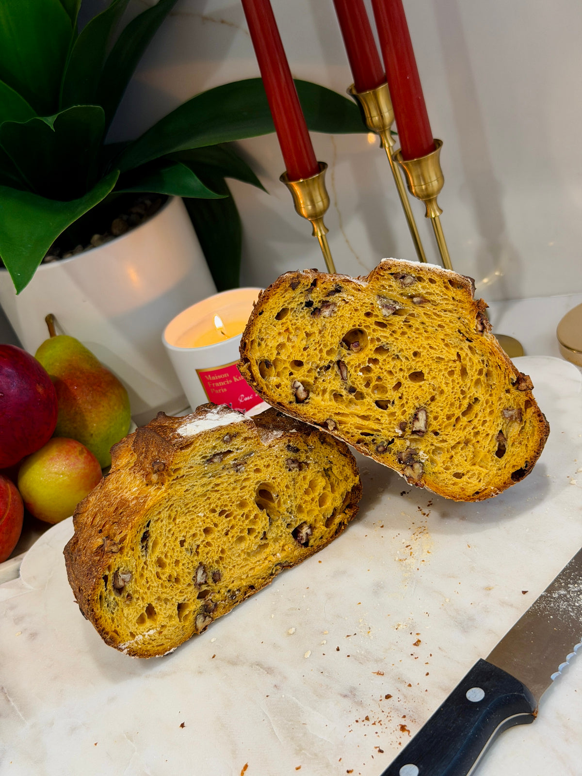 Sliced pumpkin pecan sourdough loaf showing its golden crumb